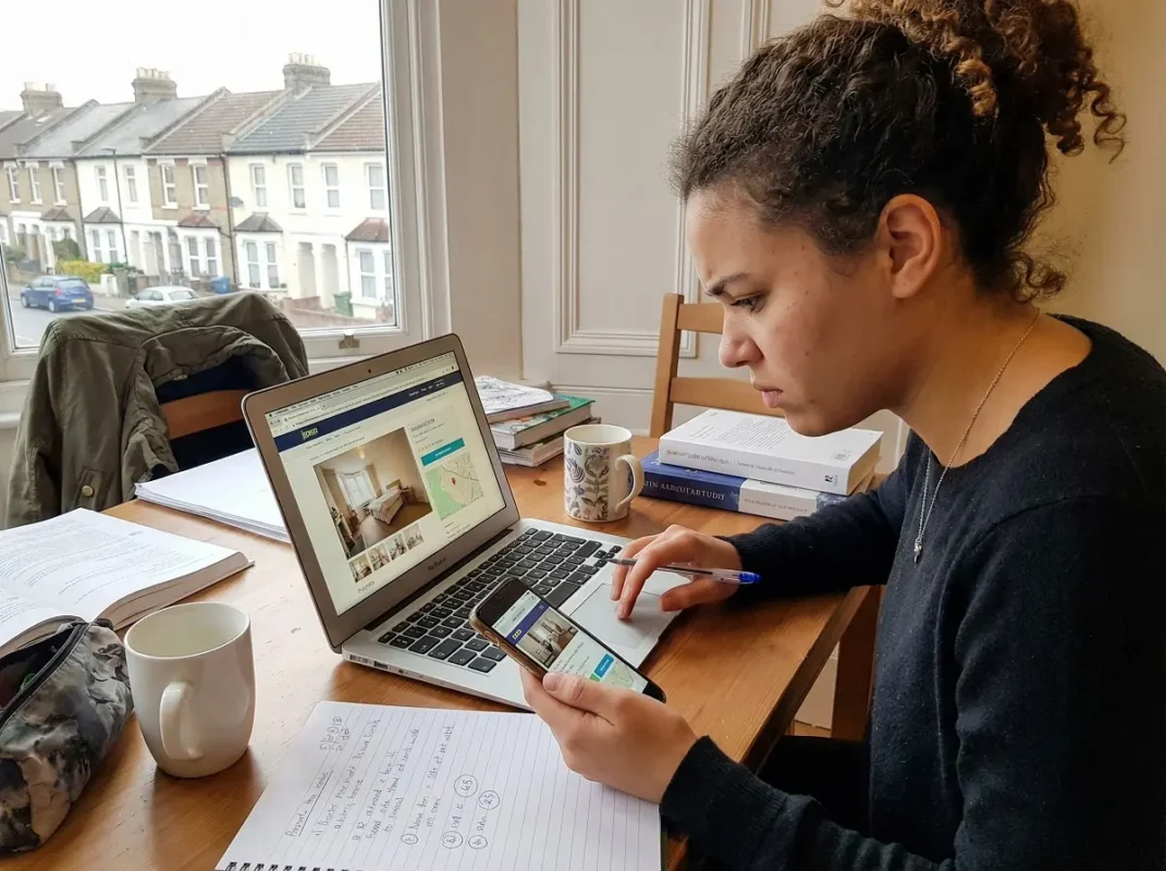 Student checking student accommodation listing carefully to avoid scams in the UK