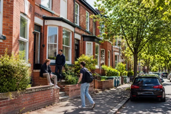 Students outside shared red-brick student houses in Headingley Leeds, showing local student housing and neighbourhood living.