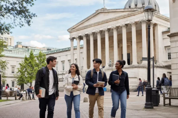 Students walking near a University College London style campus building, showing UCL as one of the hardest universities to get into in the UK.